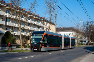 LINZ, AUSTRIA - MARCH 26, 2022. Trolleybus Van Hool Exqui.City 24 #240 riding with passengers in the streets of  Linz.