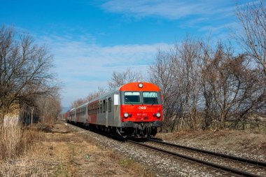 BRATISLAVA, SLOVAKIA - MARCH 03, 2022. Train #80-73 207-7 (Austria) riding with passengers in the streets of Bratislava.