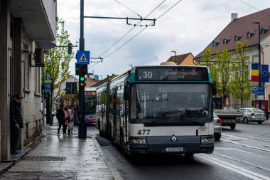 CLUJ-NAPOKA, ROMANIA - April 27, 2022. Bus Renault Agore L #477 riding with passengers in the streets of Cluj-Napoka.