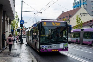 CLUJ-NAPOKA, ROMANIA - April 27, 2022. Trolleybus Solaris Trollino 18 Skoda #305 riding with passengers in the streets of Cluj-Napoka.