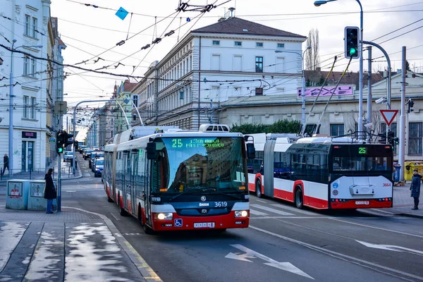 BRNO, CZECH REPUBLIC - February 25, 2022. Trolleybuses Skoda 31Tr SOR #3619 and Skoda 27Tr Solaris #3664 riding with passengers in the streets of Brno.