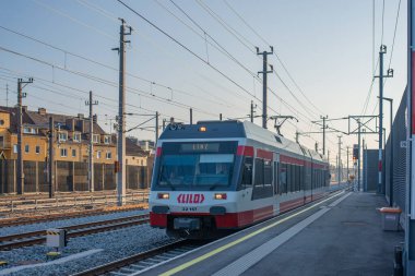 LINZ, AUSTRIA - MARCH 26, 2022. Train Stadler ET 22 #22 157 riding with passengers in the streets of  Linz.
