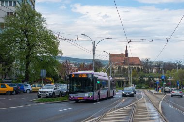 CLUJ-NAPOKA, ROMANIA - April 27, 2022. Trolleybus Solaris Trollino 18 Skoda #327 riding with passengers in the streets of Cluj-Napoka.