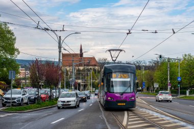 CLUJ-NAPOKA, ROMANIA - April 27, 2022. Tram Astra Imperio #88 riding with passengers in the streets of Cluj-Napoka.