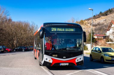 BRATISLAVA, SLOVAKIA - 11 Mart 2022. Elektrik otobüsü SOR NS 12 Elektrik # 3015 Bratislava sokaklarında yolcularla birlikte.