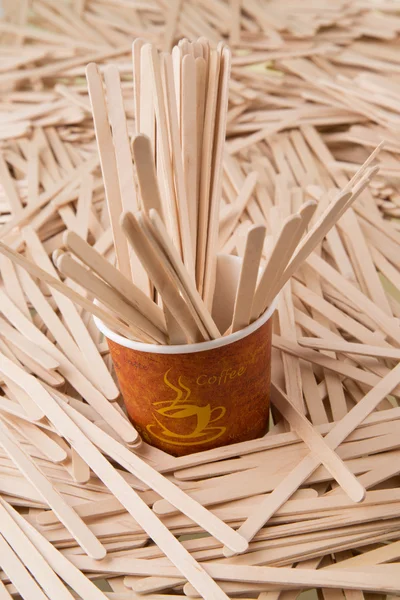 Wooden stirrers and paper coffee cup — Stock Photo, Image