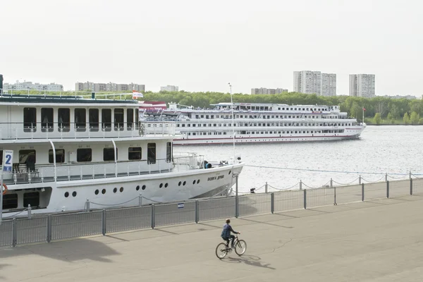 Gemilerde Moskova Nehri ve bisiklet üstünde bir oğlan