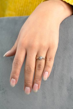 Güzel bir nişan yüzüğü takan genç bir kadın.