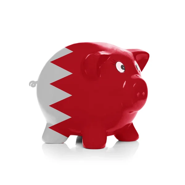 Piggy bank with flag coating over it - Bahrain — Stock Photo, Image