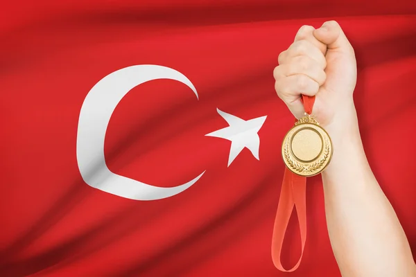 Medal in hand with flag on background - Turkey — Stock Photo, Image