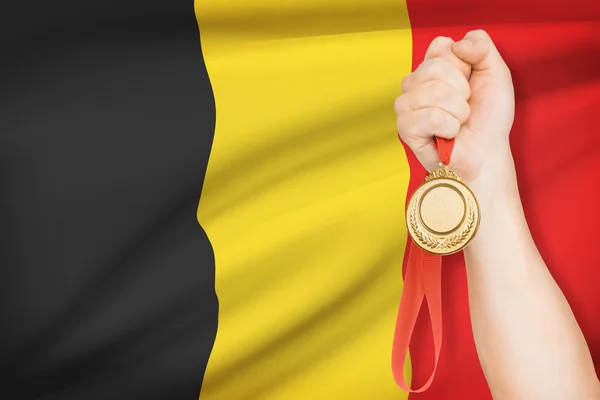 Medal in hand with flag on background - Kingdom of Belgium — Stock Photo, Image