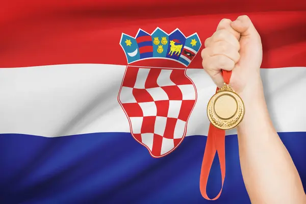 Medal in hand with flag on background - Republic of Croatia — Stock Photo, Image