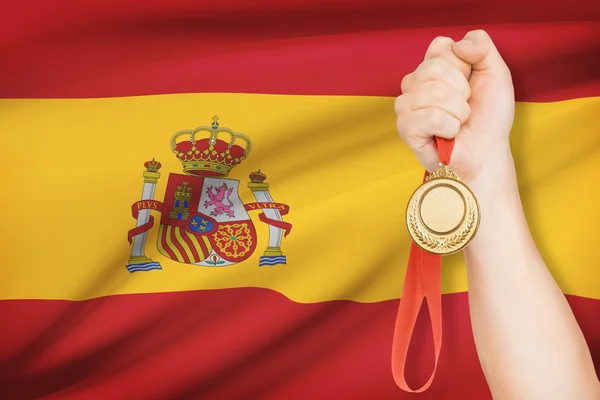 Medal in hand with flag on background - Kingdom of Spain — Stock Photo, Image
