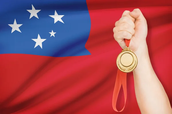 Medal in hand with flag on background - Independent State of Samoa — Stock Photo, Image