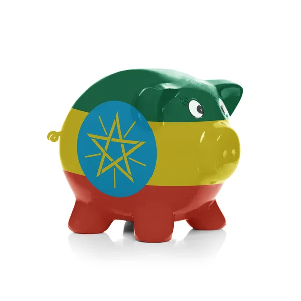 Piggy bank with flag coating over it - Ethiopia — Stock Photo, Image