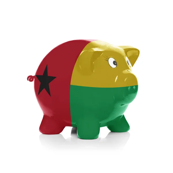 Piggy bank with flag coating over it - Guinea Bissau — Stock Photo, Image