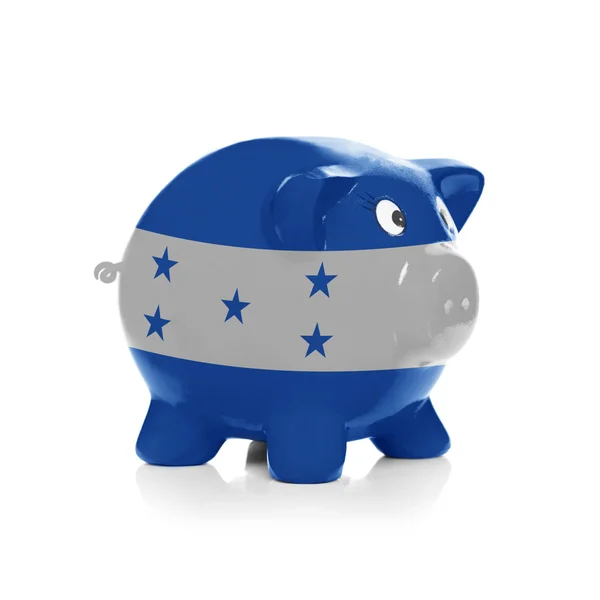 Piggy bank met vlag coating overheen - honduras — Stockfoto
