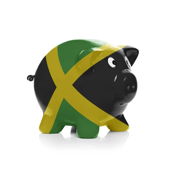 Piggy bank with flag coating over it - Jamaica — Stock Photo, Image