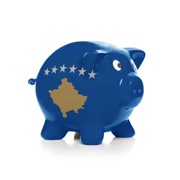 Piggy bank with flag coating over it - Kosovo — Stock Photo, Image