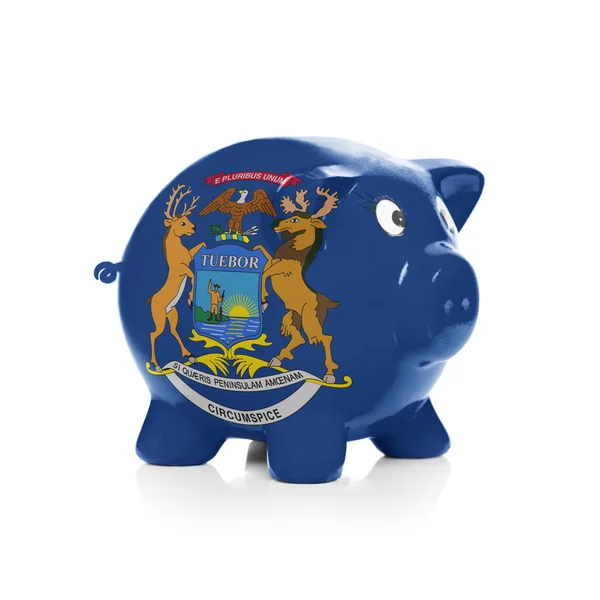 Piggy bank with flag coating over it - State of Michigan — Stock Photo, Image