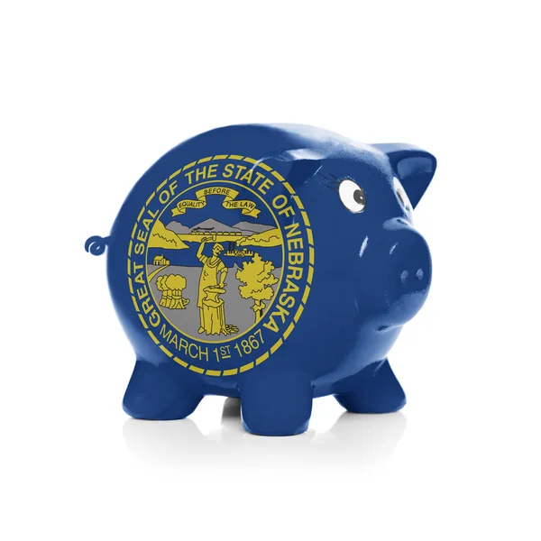 Piggy bank with flag coating over it - State of Nebraska — Stock Photo, Image