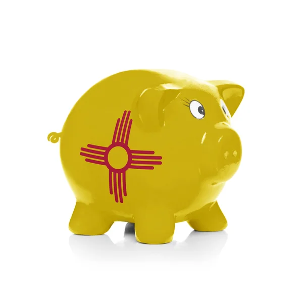 Piggy bank with flag coating over it - State of New Mexico — Stock Photo, Image