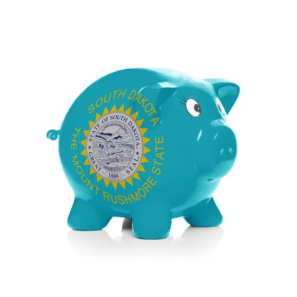 Piggy bank with flag coating over it - State of South Dakota — Stock Photo, Image