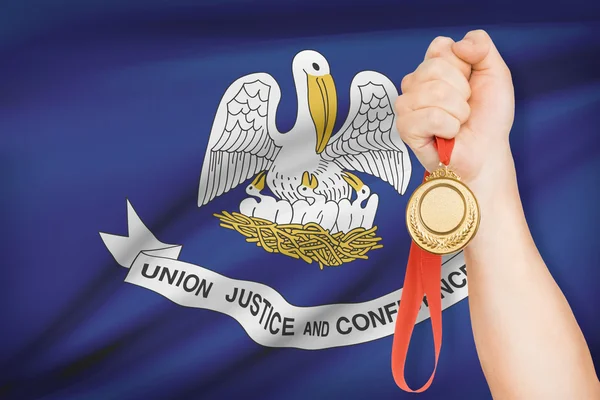 Medal in hand with flag on background - State of Louisiana. Part of a series. — Stock Photo, Image