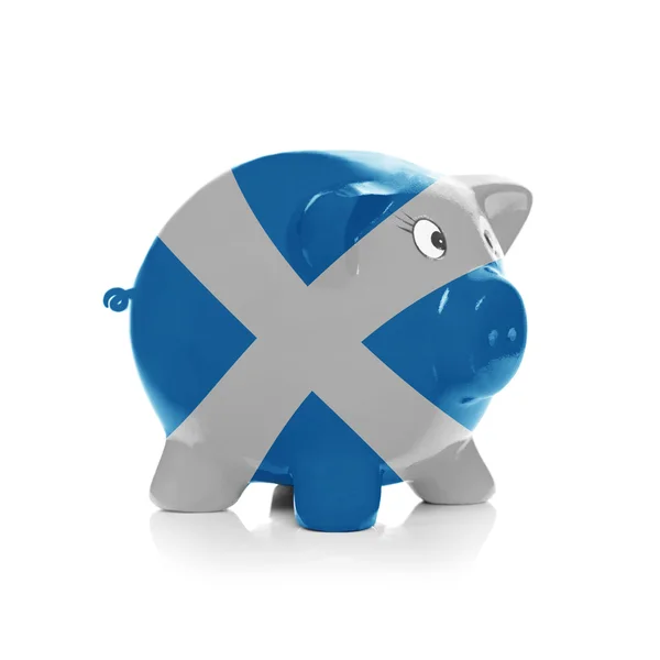 Piggy bank with flag coating over it - Scotland — Stock Photo, Image