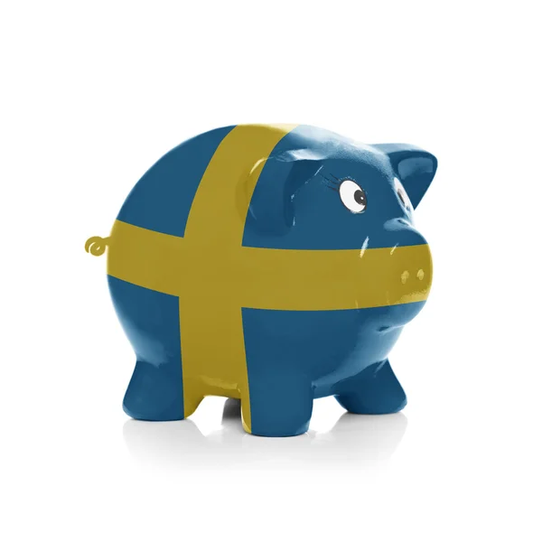 Sparschwein mit Flagge Beschichtung drüber - Schweden — Stockfoto