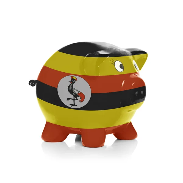 储钱罐在它-乌干达国旗涂 — 图库照片
