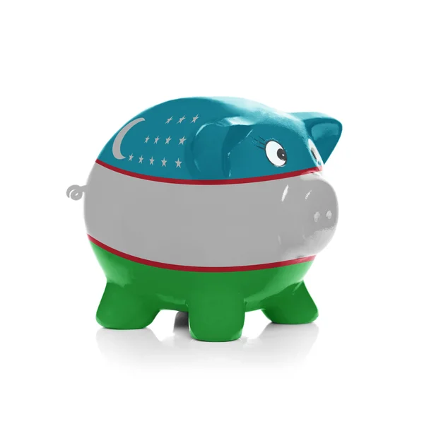 Piggy bank met vlag coating overheen - Oezbekistan — Stockfoto