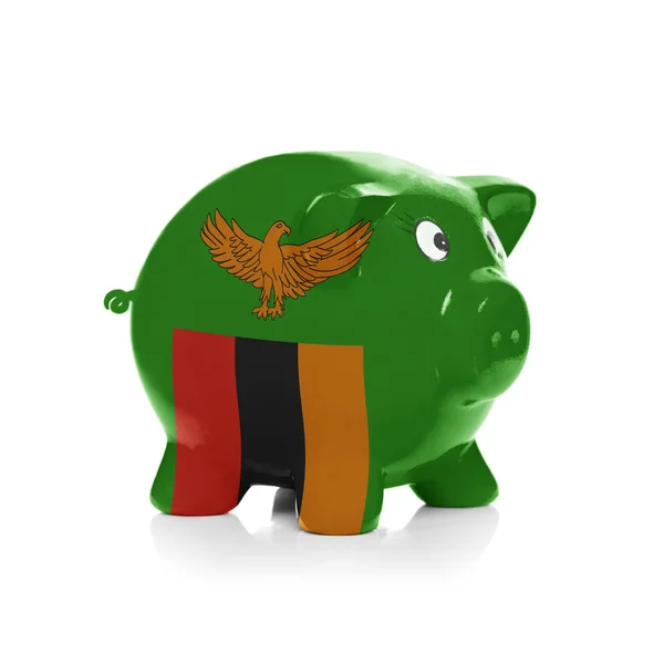 Piggy bank with flag coating over it - Zambia — Stock Photo, Image