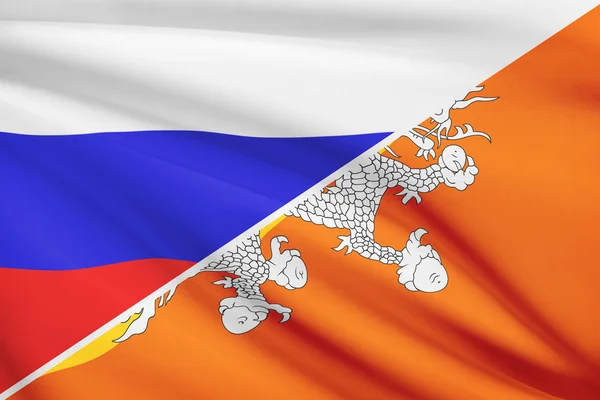 Series of ruffled flags. Russia and Bhutan. — Stock Photo, Image