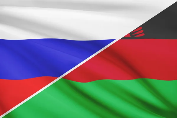 Серия трепал флагов. Россия и Республики Малави. — стоковое фото