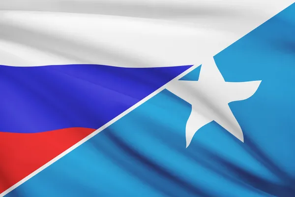 Series of ruffled flags. Russia and Federal Republic of Somalia. — Stock Photo, Image