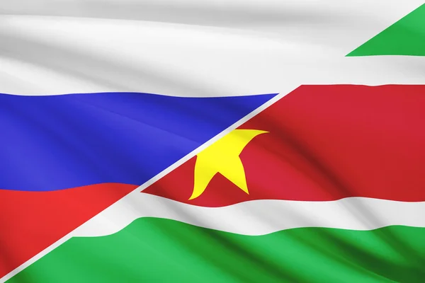 Series of ruffled flags. Russia and Republic of Suriname. — Stock Photo, Image