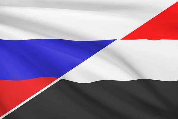 Seria potargane flagi. Rosja a Republiką Jemeńską. — Zdjęcie stockowe