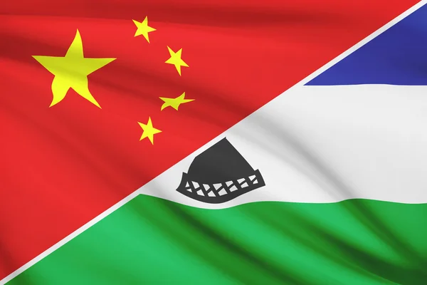 Series of ruffled flags. China and Kingdom of Lesotho. — Stock Photo, Image