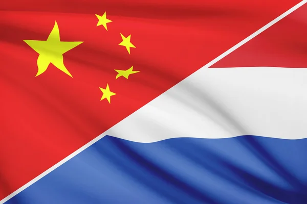 Series of ruffled flags. China and Netherlands. — Stock Photo, Image