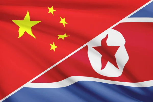 Series of ruffled flags. China and Democratic People's Republic of Korea. — Stock Photo, Image
