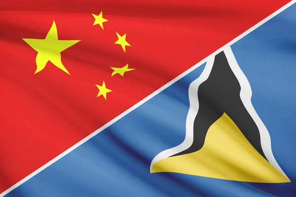 Series of ruffled flags. China and Saint Lucia. — Stock Photo, Image