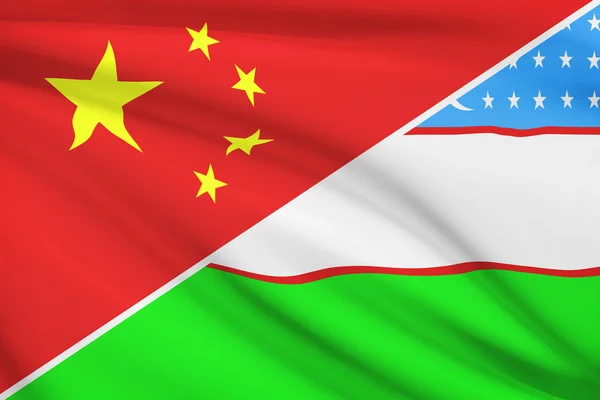 Series of ruffled flags. China and Republic of Uzbekistan. — Stock Photo, Image