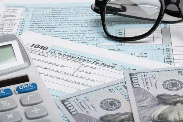 United States of America Tax Form 1040 with calculator, dollars and glasses — Stock Photo, Image