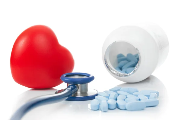 Stethoscope with red heart and pills - studio shoot on white — Stock Photo, Image