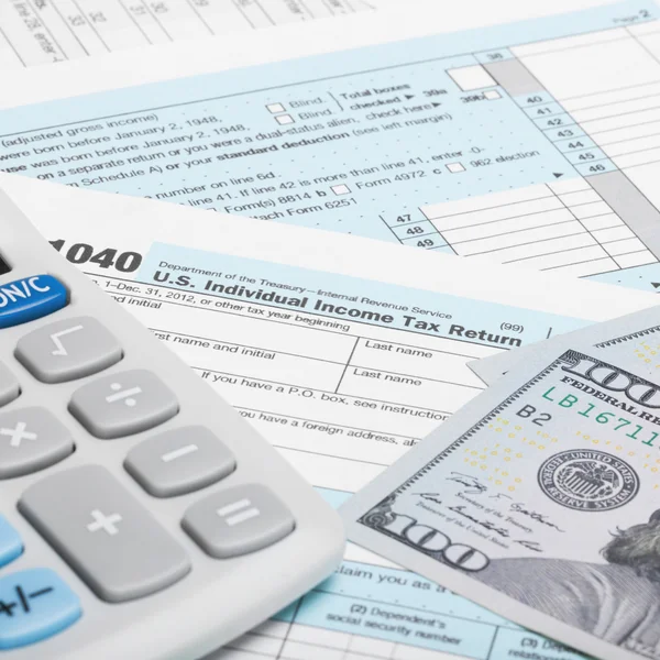 United States of America Tax Form 1040 with calculator and US do - 1 to 1 ratio — Stock Photo, Image