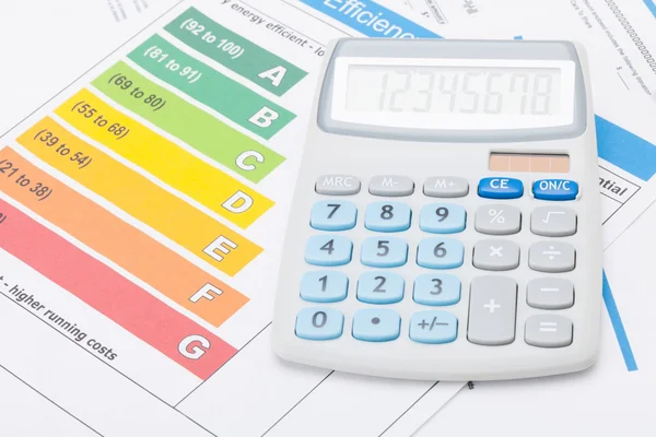 Calculator with energy efficiency chart - studio shot — Stock Photo, Image