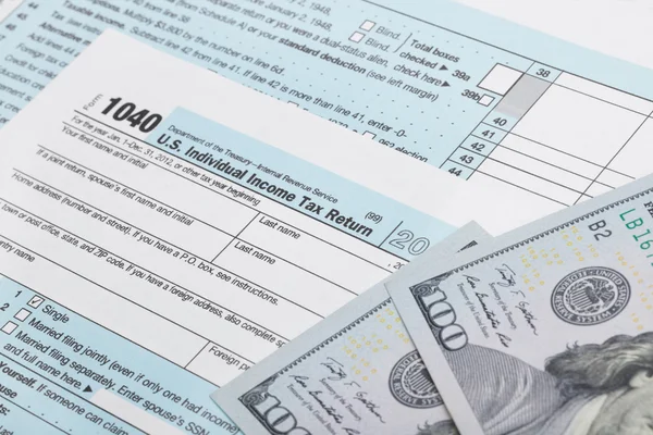 USA Tax Form 1040 with 100 US dollar bills — Stock Photo, Image