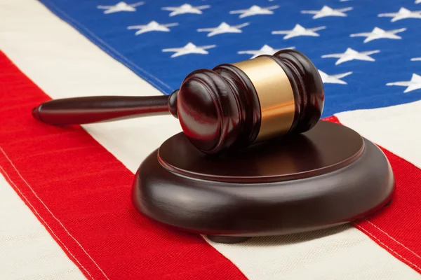 Wooden judge gavel and soundboard laying over USA flag - studio shoot — Stock Photo, Image