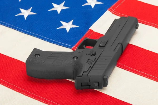 Handgun laying over USA flag - studio shoot — Stock Photo, Image